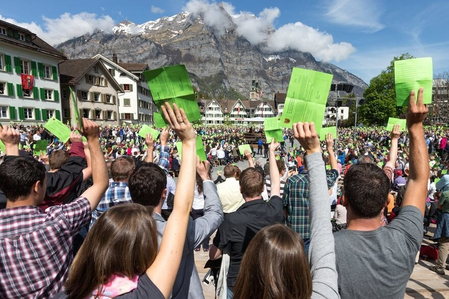 Traditional open-air voting raising hands in Switzerland