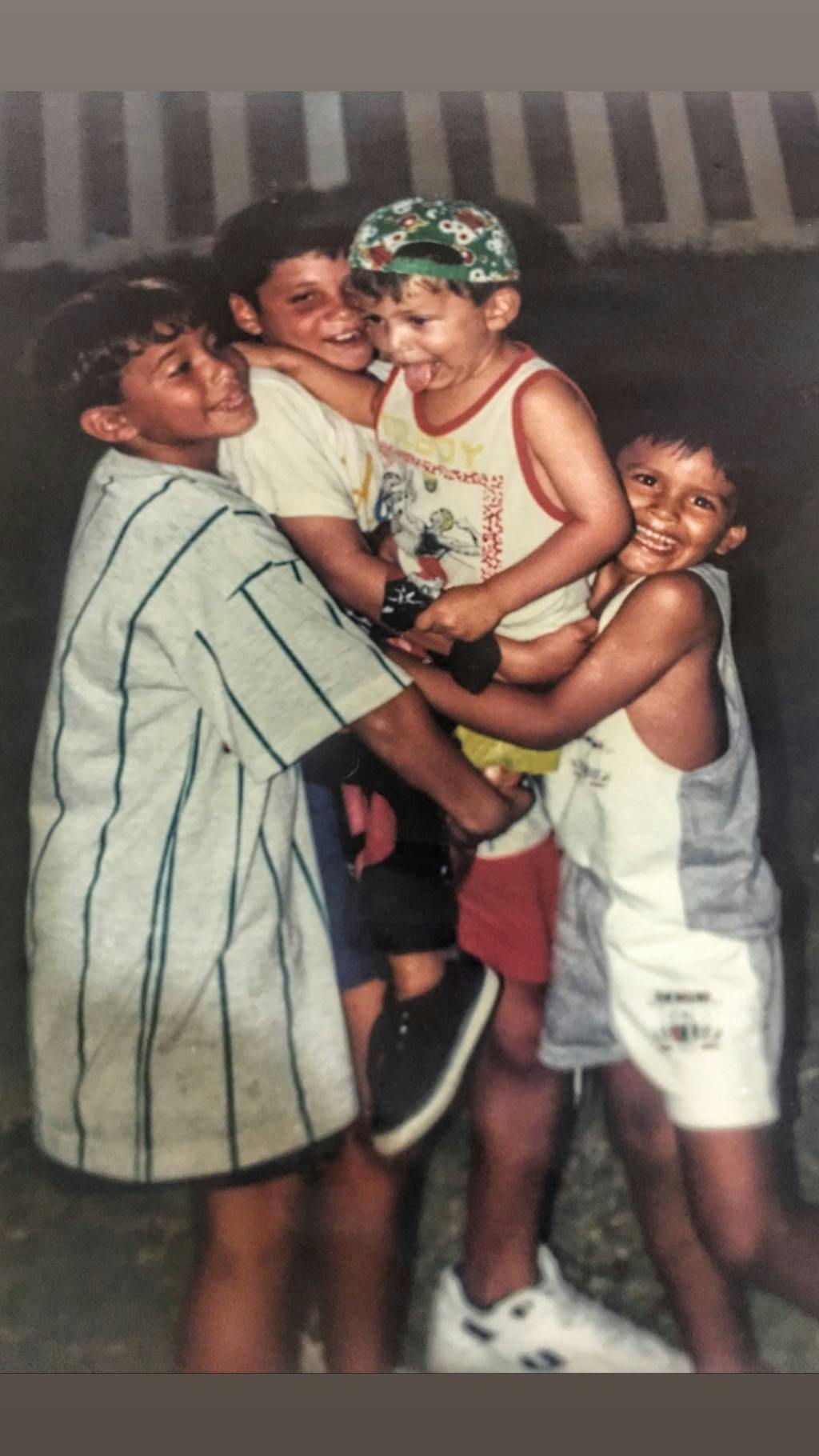 Me and my cousins carrying my little brother on one of our trips to the beach.