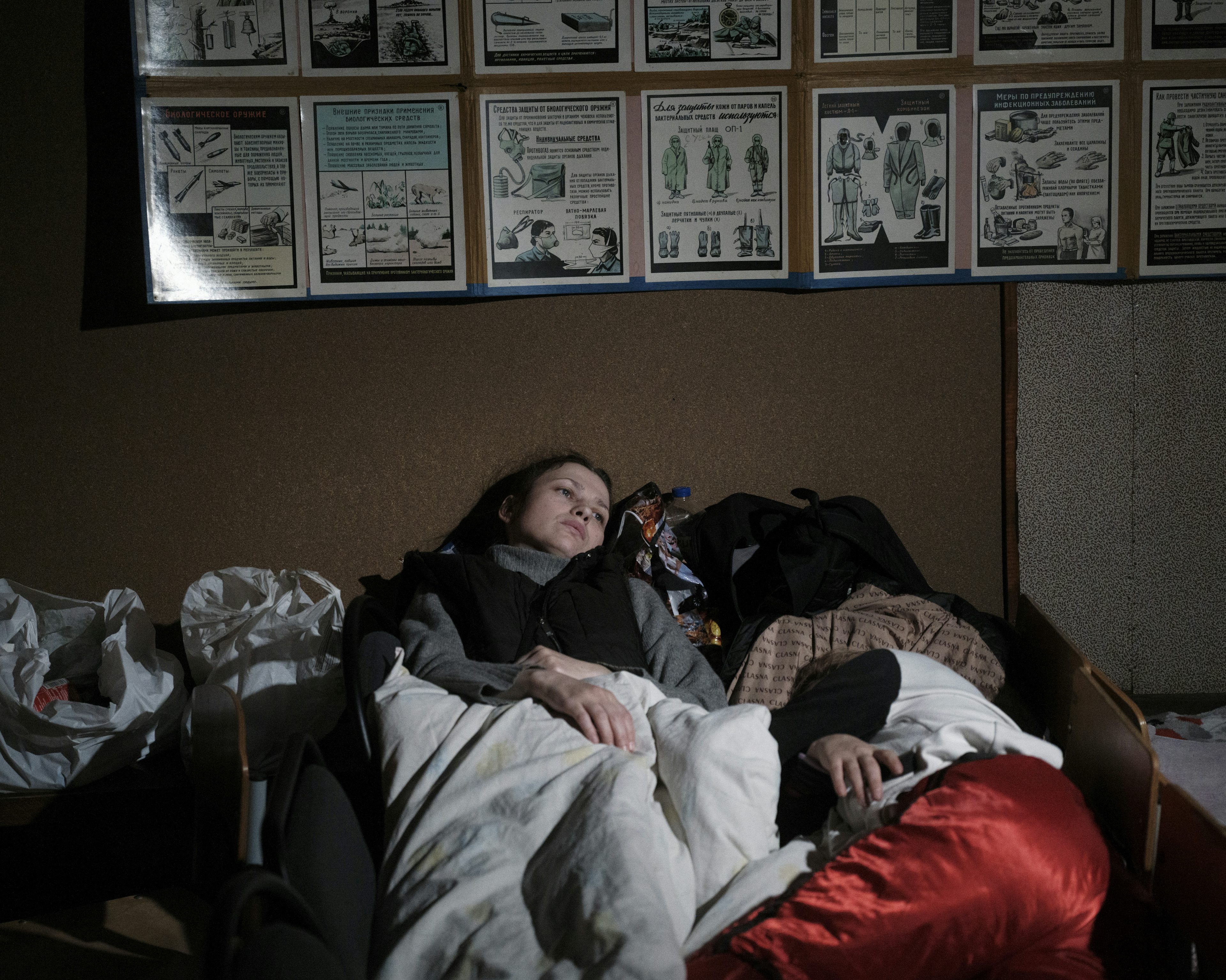 UKRAINE. Kyiv. 3 March 2022. Mother and daughter sleep in a bomb shelter under a school on the outskirts of Kyiv. Photo by Lorenzo Meloni