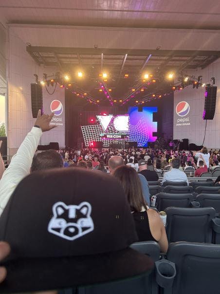 A blurry Curio Cards snapback seen at a Busta Rhymes concert. Credit: konstantin.