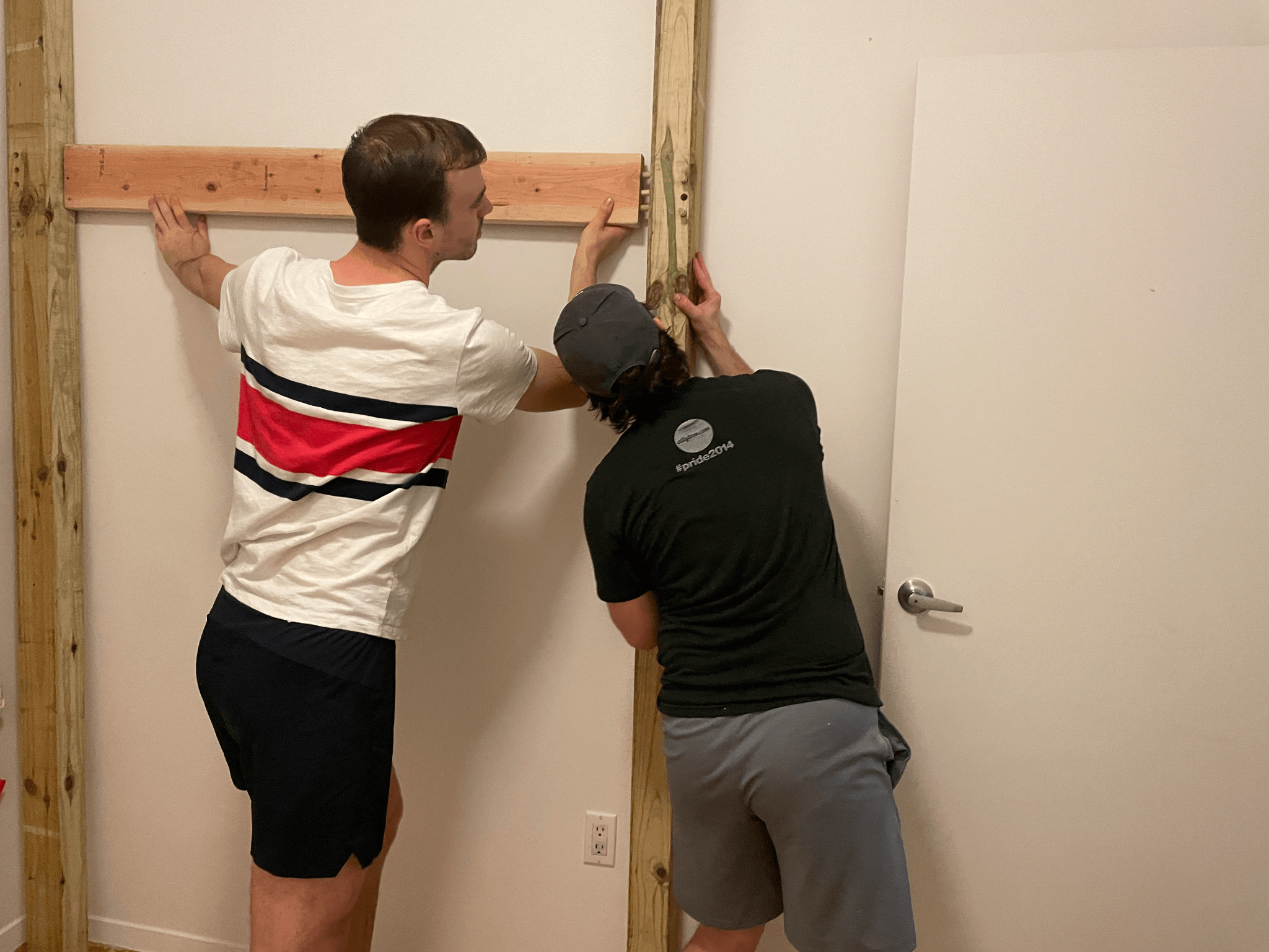 Zack and George assemble the loft. Here, they join the loft legs to a plank via dowels.